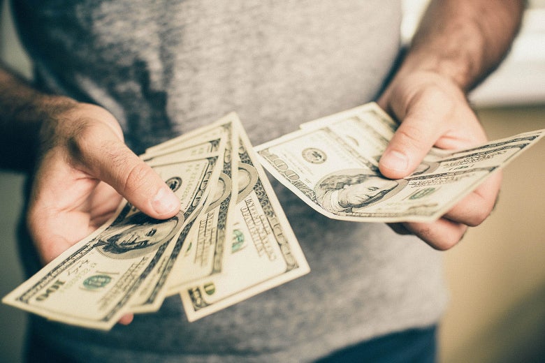 Person sifts through cash.